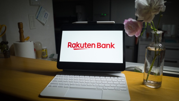 The Rakuten Bank Ltd. logo on a laptop computer screen arranged in Yokohama, Japan, on Wednesday, Dec. 13, 2023. Founded by former investment banker Hiroshi Mikitani, Rakuten Group Inc. has expanded beyond its core e-commerce operation. Many of those bets, such as in online banking and securities, have been lucrative, but a 2020 foray into Japan’s saturated mobile phone market has pulled it deeper in debt. Photographer: Kentaro Takahashi/Bloomberg