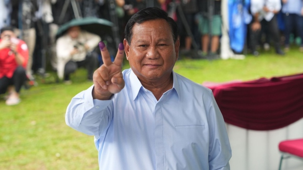 Prabowo Subianto, presidential candidate and Indonesia's defense minister, shows his fingers marked with indelible ink after casting his ballot in Bojong Koneng village, West Java, Indonesia, on Wednesday, Feb. 14, 2024. Indonesians are voting in an election that has turned outgoing President Joko Widodo into a polarizing figure amid mounting backlash over moves to get his preferred successor in power to continue his policies.