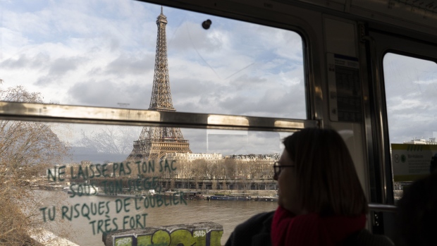 A Paris Metro train travels on a bridge across the River Seine, with the Eiffel Tower beyond in central Paris, France, on Wednesday, Feb. 14, 2024. Olympic organizers began working with Paris officials three years ago to clean the Seine, a venue for Paris 2024 Olympic swimming events.