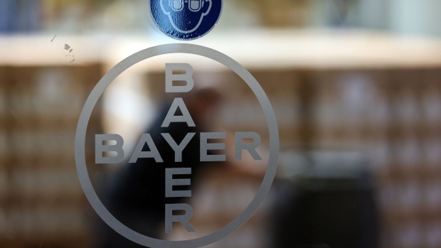 The Bayer AG logo sits on a glass panel in the Bayer CropScience AG herbicide research and development facility in Frankfurt, Germany, on Monday, July 13, 2020. Germany’s economy continues to recover following the easing of coronavirus-related restrictions, but remains well below capacity, according to a government report. Photographer: Alex Kraus/Bloomberg