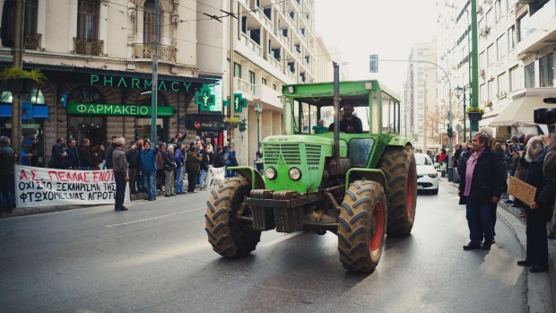 Farmers drive their tractors into the city center during a protest in Athens, Greece, on Feb. 20. Photographer: Ioana Epure/Bloomberg