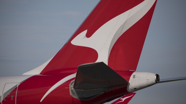The Qantas Airways Ltd. logo displayed on an aircraft tail at Sydney Airport in Sydney, Australia, on Tuesday, August 22, 2023. Qantas is scheduled to release earnings results on Aug. 24. Photographer Brent Lewin/Bloomberg Photographer: Brent Lewin/Bloomberg