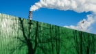 Chimneys emit vapor behind a perimeter fence with tree shadows at the Segezha Pulp and Paper Mill JSC, operated by Segezha Group, in Segezha, Russia, on Friday, March 19, 2021. Billionaire Vladimir Evtushenkov is considering an initial public offering of wood, paper and packaging producer Segezha Group after an ecommerce operator he holds a stake in notched the most successful Russian debut in nearly a decade last November. Photographer: Andrey Rudakov/Bloomberg
