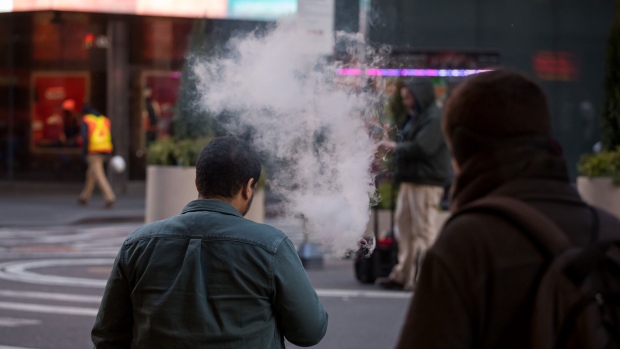 A person exhales vapor while using an electronic cigarette device in New York, U.S., on Wednesday, Jan. 8, 2020. The U.S. Food and Drug Administration said it would ban fruit and mint flavors that have been blamed for getting millions of children hooked on e-cigarettes, a months-in-the-making plan designed to curb an epidemic of underage vaping. Photographer: Michael Nagle/Bloomberg