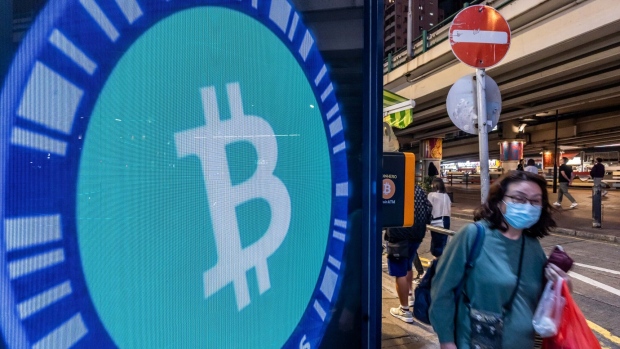 A Bitcoin logo on a screen in Hong Kong, China, on Tuesday, Dec. 5, 2023. Bitcoin shrugged off a dip in global stock markets to set another more than 19-month high, a sign of its decoupling from other assets. Photographer: Paul Yeung/Bloomberg