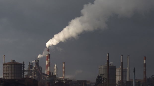 Emissions rise from chimneys at the Nippon Steel & Sumitomo Metal Corp. plant in Kashima, Japan.