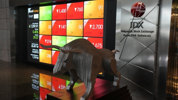 A bull statue in front of an electronic board displaying stock prices at the lobby of the Indonesia Stock Exchange (IDX) in Jakarta, Indonesia, on Monday, April 11, 2022. GoTo Group, Indonesia’s biggest tech company, surged on its first day of trading after raising $1.1 billion in one of the world’s largest initial public offerings this year. Photographer: Dimas Ardian/Bloomberg