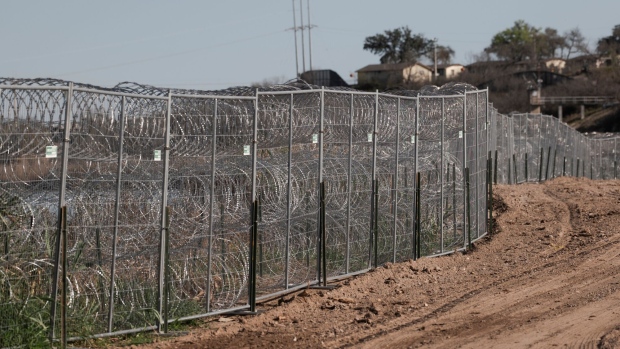 Fences lined with concertina wire along the banks of the Rio Grande River in Shelby Park in Eagle Pass, Texas, US, on Friday, Feb. 23, 2024. The US Border Patrol will be forced to make operational cuts if lawmakers don't authorize funding to address the border crisis, the agency's chief has warned.