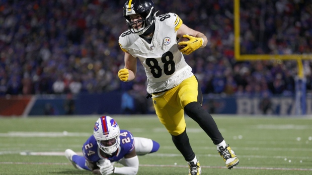 ORCHARD PARK, NEW YORK - JANUARY 15: Pat Freiermuth #88 of the Pittsburgh Steelers carries the ball against Kaiir Elam #24 of the Buffalo Bills during the second quarter at Highmark Stadium on January 15, 2024 in Orchard Park, New York. (Photo by Sarah Stier/Getty Images)