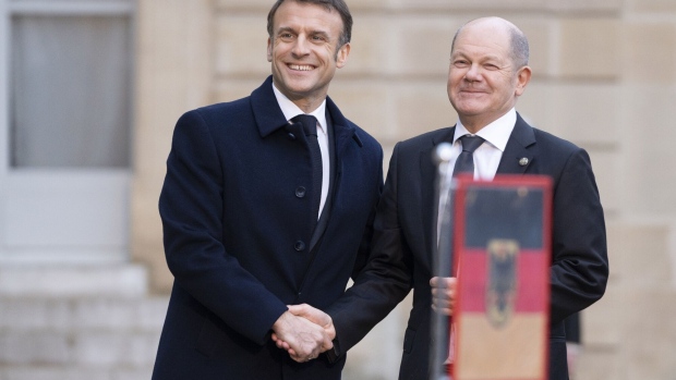 Emmanuel Macron, France’s president, left, greets Olaf Scholz, Germany’s chancellor, at the Elysee Palace in Paris, France, on Monday, Feb. 26, 2024.