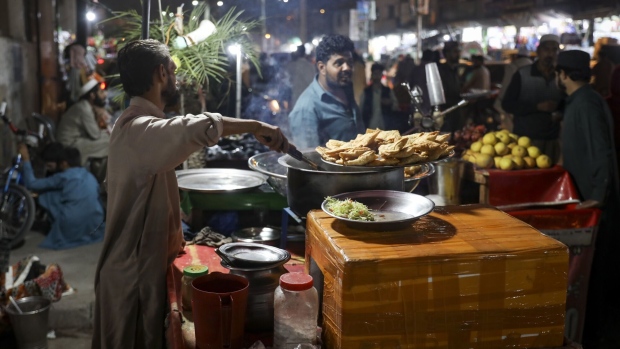 <p>A vendor prepares food at a market in Rawalpindi, Pakistan.</p>
