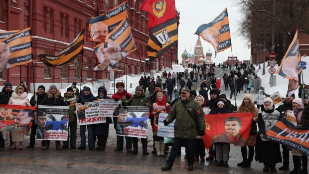 Members of the National Liberation Movement hold posters of Putin and Stalin during a rally on Red Square.