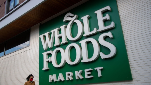 A pedestrian wearing a protective mask walks by a Whole Foods Market Inc. grocery store in Washington, D.C., U.S., on Tuesday, Oct. 6, 2020. For several months the Trump administration has operated at the White House in violation of several D.C. virus regulations including holding gatherings exceeding the 50-person limit where most attendees did not wear masks. Photographer: Graeme Sloan/Bloomberg