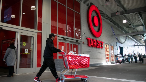 <p>A shopper leaves a Target store in New York.</p>