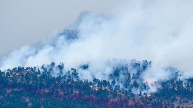 Smoke rises from the 2020 Cal-Wood Fire as it burns in Boulder County, Colo. Wildfires have made the state increasingly unprofitable for private insurers. Photographer: Matthew Jonas/MediaNews Group/Boulder Daily Camera/Getty Images