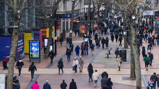 Shoppers walk along a pedestrianised shopping area in Birmingham, UK. Photographer: Chris Ratcliffe/Bloomberg