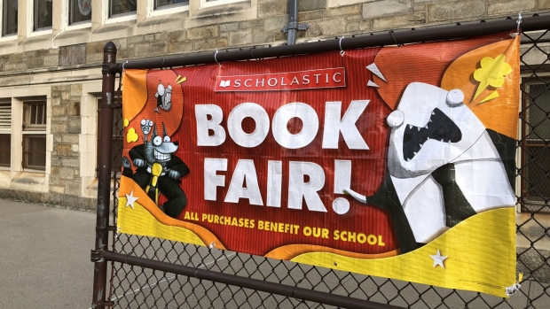 Scholastic Book Fair banner outside Catholic school, Queens, New York. Photographer: Lindsey Nicholson/Universal Images Group/Getty Images