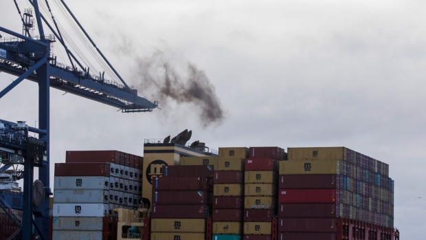 Smoke rises from a container ship's funnels on the dockside at the Port of Felixstowe Ltd. in Felixstowe, U.K., on Thursday, Nov. 19, 2020. The organization responsible for setting global environmental standards for shipping approved rules designed to curb the industry's carbon emissions, triggering criticism that its measures won't do enough to help tackle climate change. Photographer: Chris Ratcliffe/Bloomberg