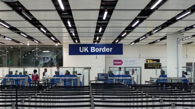 UK Border Force check passport at Gatwick Airport.