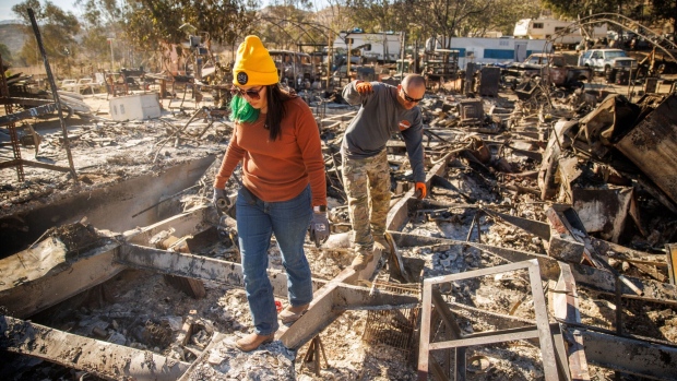 <p>Relatives walk through the remains of their family's home after it was destroyed during the Highland Fire in Aguanga, California, US, on Tuesday, Oct. 31, 2023. </p>