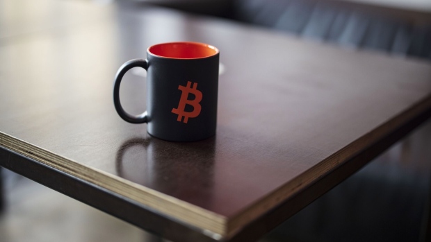 A Bitcoin logo on a mug inside the venue of the Paralelni Polis project, an organization combining art, social sciences and modern technology, in Prague, Czech Republic, on Friday, Jan. 5, 2024. Bitcoin has been on a tear ahead of an upcoming Jan. 10 deadline that could see the US Securities and Exchange Commission approve the first exchange-traded fund tied directly to the asset’s spot price. Photographer: Milan Jaros/Bloomberg