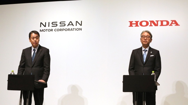 Nissan's CEO Uchida, left, and Honda's CEO Mibe during a news conference on March 15.