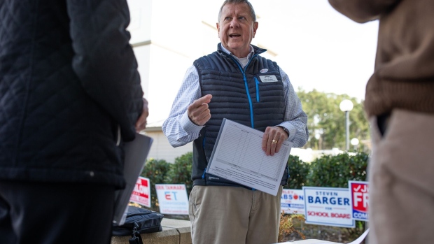 Bob Fulton speaks with members of the Brunswick County Democratic Party outside of an early voting location in Southport. Photographer: Madeline Gray/Bloomberg