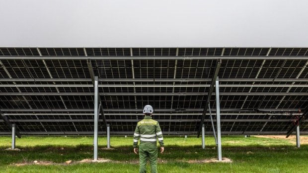 An engineer inspects the underside of a row of photovoltaic panels at the Iberdrola SA BaCa hybrid wind-solar plant in the Vallejera district of Burgos, Spain, on Wednesday, Feb. 14, 2024. Iberdrola reports full year earnings on Feb. 22. Photographer: Angel Garcia/Bloomberg
