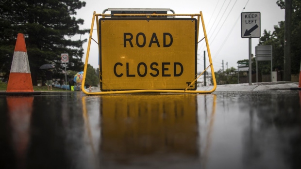 A sign for a closed road in Windsor, New South Wales, Australia, on Monday, March 22, 2021. Western Sydney and the NSW Mid-North coast are bearing the brunt of the relentless downpour that has caused the Warragamba Dam, Sydney’s primary source of water, to overflow for the first time in five years, and caused severe damage to property and roads. Photographer: Brent Lewin/Bloomberg