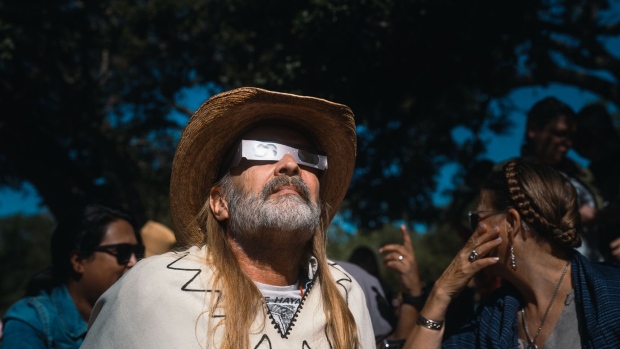 A spectator wears solar viewing glasses during a “ring of fire” solar eclipse in Driftwood, Texas, on Oct. 14, 2023.