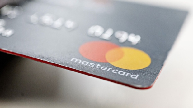 A Mastercard Inc. credit card is arranged for a photograph in Tiskilwa, Illinois, U.S., on Tuesday, Sept. 18, 2018. Visa and Mastercard agreed to pay as much as $6.2 billion to end a long-running price-fixing case brought by merchants over card fees, the largest-ever class action settlement of an antitrust case. Photographer: Daniel Acker/Bloomberg