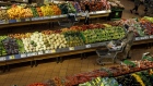 <p>Shoppers walk through produce aisles at a grocery store in Toronto, Ontario.</p>