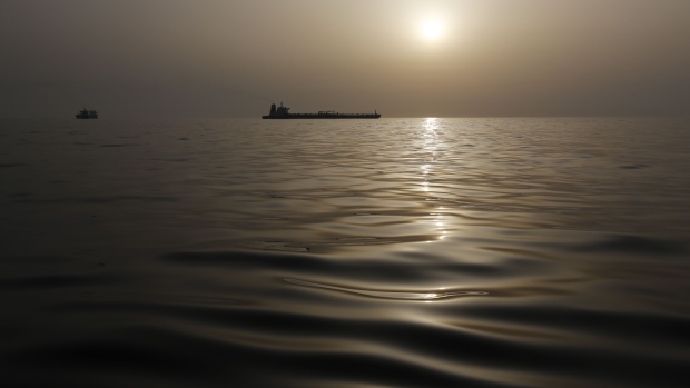 The impounded Iranian crude oil tanker, Grace 1, right, is silhouetted as it sits anchored off the coast of Gibraltar, on Saturday, July 20, 2019. Tensions have flared in the Strait of Hormuz in recent weeks as Iran resists U.S. sanctions that are crippling its oil exports and lashes out after the seizure on July 4 of one of its ships near Gibraltar. Photographer: Marcelo del Pozo/Bloomberg
