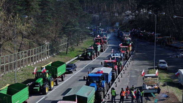 <p>Farmers with their tractors block the A12 highway border crossing to Germany, near Slubice, Poland, on March 18. </p>