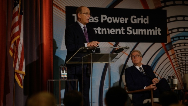BlackRock CEO Larry Fink delivers opening remarks beside Dan Patrick, lieutenant governor of Texas, at the Texas Power Grid Investment Summit in Houston on Feb. 6.