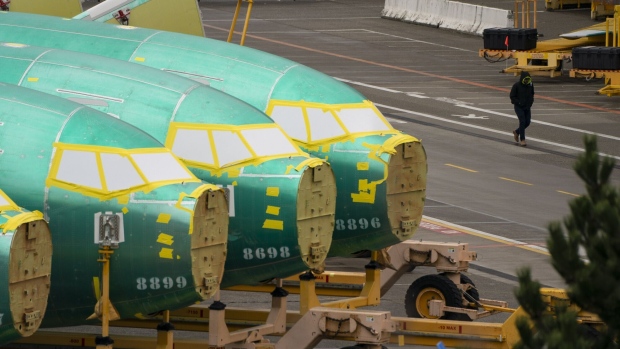 A worker walks near Boeing 737 fuselages outside the Boeing Co. manufacturing facility in Renton, Washington, US.