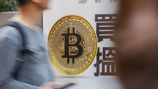 The Bitcoin logo in Hong Kong, China, on Tuesday, Dec. 5, 2023. Bitcoin shrugged off a dip in global stock markets to set another more than 19-month high, a sign of its decoupling from other assets. Photographer: Paul Yeung/Bloomberg