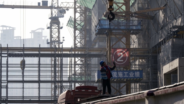 A worker at the construction site of a residential development in Shanghai, China, on Tuesday, March 19, 2024. China's property-debt crisis has entered a new stage, as tensions have increasingly shifted to developers' court battles with creditors over debt restructuring plans, and the once-unthinkable consequence of liquidation orders. Photographer: Qilai Shen/Bloomberg