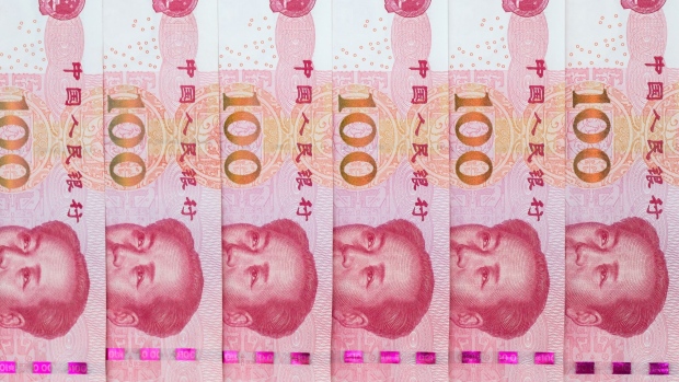 Chinese one-hundred yuan banknotes are arranged for a photograph in Hong Kong, China, on Thursday, April 23, 2020. The People's Bank of China (PBOC) has cut short- and medium-term rates recently on top of liquidity injections, loan rollovers and easier regulatory rules. Photographer: Paul Yeung/Bloomberg