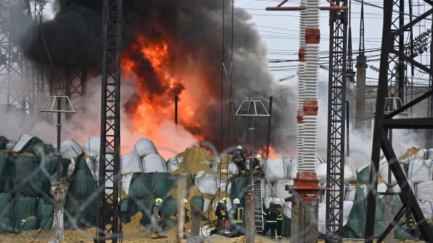 Firefighters extinguish a fire at an electrical substation after a missile attack in Kharkiv, on March 22, 2024. Photographer: Sergey Bobok/AFP/Getty Images