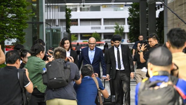 S. Iswaran, center, leaves the Singapore State Courts on March 25.