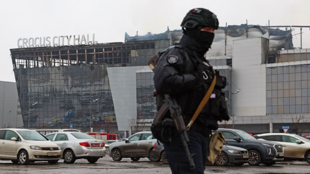 A law enforcement officer patrols the scene of the gun attack at the Crocus City Hall concert hall in Krasnogorsk, outside Moscow, on March 23, 2024. Photographer: STR/AFP/Getty Images