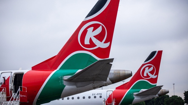Livery for Kenya Airways Ltd. sits on the tailfins of passenger aircraft on the tarmac at Jomo Kenyatta International Airport in Nairobi, Kenya, on Wednesday, July 15, 2020. Kenya Airways Plc started a three-month round of job cuts as lawmakers debate a bill to nationalize the carrier and its losses mount due to the impact of the coronavirus pandemic. Photographer: Patrick Meinhardt/Bloomberg