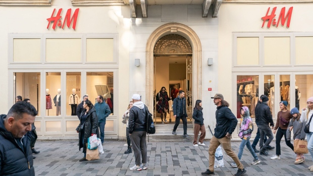 Shoppers pass an H&M clothing store in Istanbul.