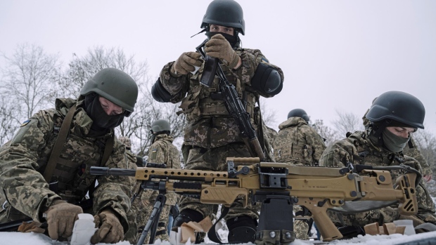 Members of the Siberian Battalion prepare weapons during military exercises with the International Legion of the Armed Forces of Ukraine at an undisclosed location in Ukraine, on Thursday, Dec. 13, 2023. Newly declassified intelligence shared with some congressional officials puts Russian losses in the war so far at 315,000 deaths or injuries, a person familiar with the talks said. Photographer: Andrew Kravchenko/Bloomberg