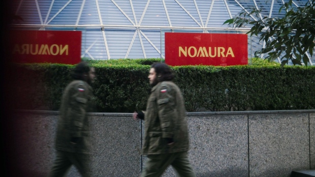 Signage for Nomura Holdings Inc. outside the Nomura Securities Co. headquarters building in Tokyo, Japan, on Wednesday, Jan. 31, 2024. Nomura Holdings surprised investors with a buyback of up to 100 billion yen ($677 million) as it showed progress in trimming costs and its key investment banking and trading division returned to profit. Photographer: Kentaro Takahashi/Bloomberg