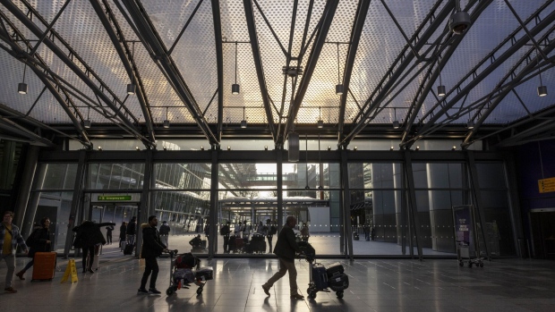 <p>Passengers in the departures hall at Heathrow Airport in London.</p>