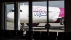 A Wizz Air Holdings Plc passenger aircraft parked at a gate at Budapest Ferenc Liszt International Airport in Budapest, Hungary, on Wednesday, Aug. 4, 2021. The Hungarian government has made a non-binding offer to buy Budapest Airport, according to people familiar with the matter, as Prime Minister Viktor Orban seeks to gain control of what had been one of the fastest growing hubs in the region before the coronavirus pandemic. Photographer: Akos Stiller/Bloomberg