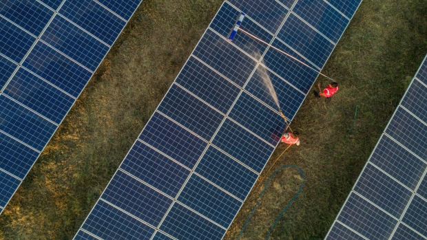 <p>Workers wash photovoltaic panels at a solar farm in Pavagada, Karnataka, India.</p>