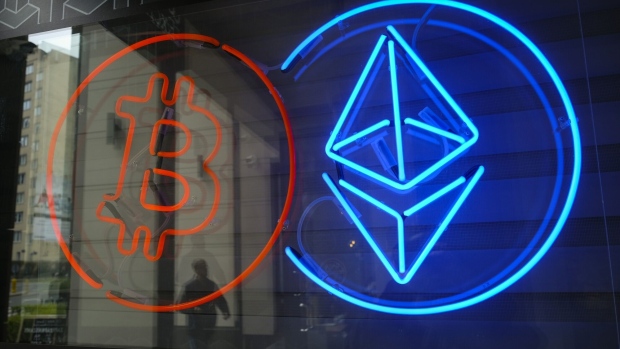 The neon logos of Bitcoin and Ethereum cryptocurrencies in the window of a crypto exchange in Warsaw, Poland, on Thursday, March 14, 2024. Bitcoin extended a retreat from its latest record high amid an intensifying debate about whether the bull run in cryptocurrencies is evidence of speculative froth in global markets.